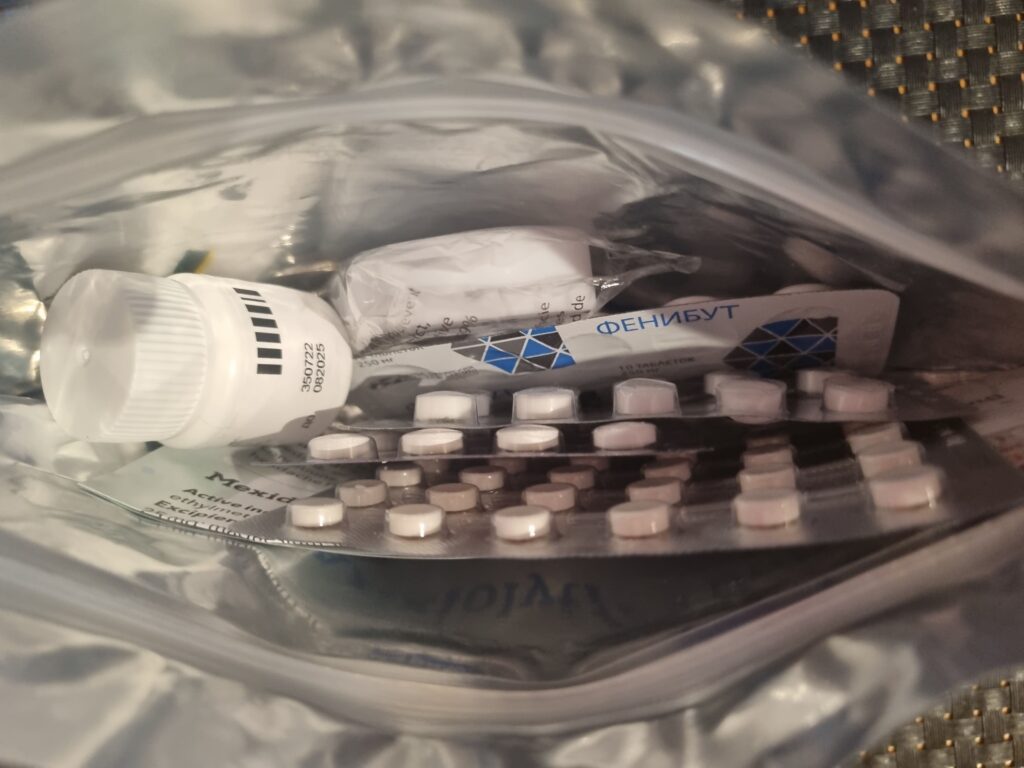 Open CosmicNootropic storage case containing capsules and pharmaceutical nootropic products used during our hands-on testing.